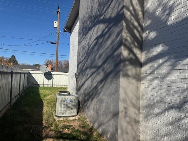 view of side of home featuring cooling unit