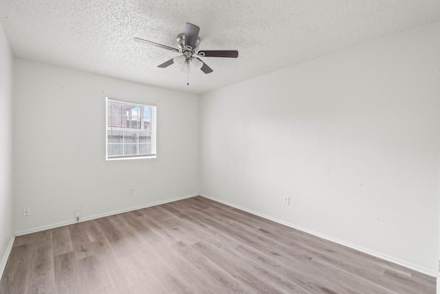 unfurnished room featuring ceiling fan, a textured ceiling, and light wood-type flooring