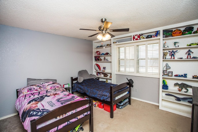 carpeted bedroom featuring a ceiling fan and a textured ceiling