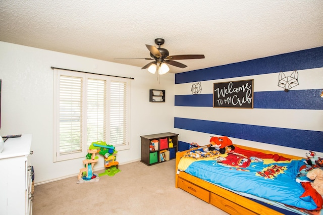 bedroom with carpet floors, a textured ceiling, and multiple windows