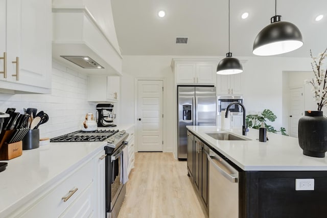 kitchen featuring white cabinetry, appliances with stainless steel finishes, sink, and custom exhaust hood