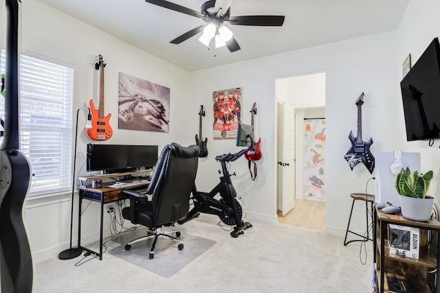 carpeted office featuring ceiling fan