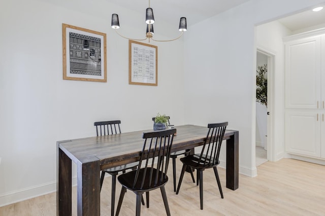 dining space with light hardwood / wood-style floors