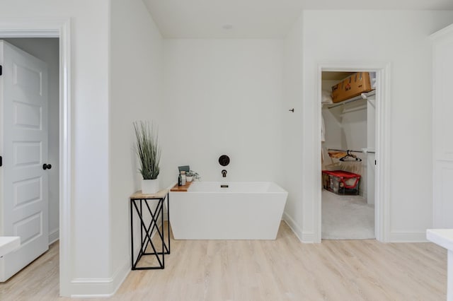 bathroom with hardwood / wood-style floors and a tub