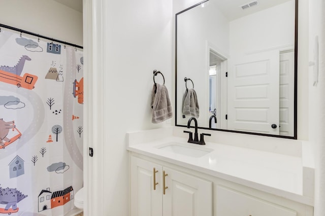 bathroom with vanity and toilet