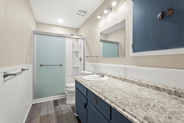 4416 33rd St, Lubbock, TX 79410 - full bath with a wainscoted wall, vanity, a shower stall, and wood finished floors