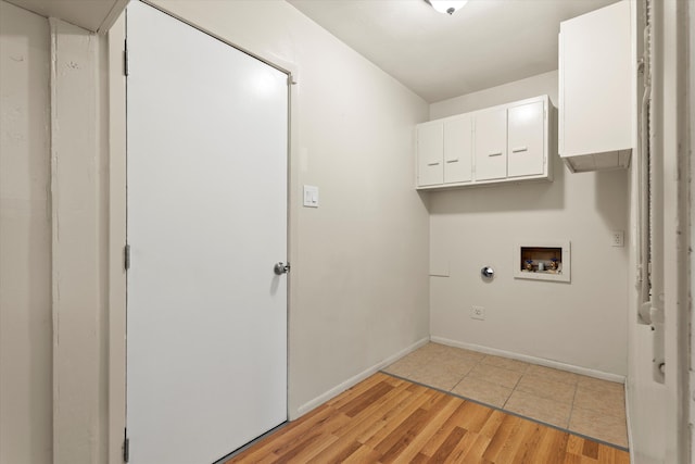 4416 33rd St, Lubbock, TX 79410 - laundry area featuring cabinet space, hookup for a washing machine, and light wood finished floors
