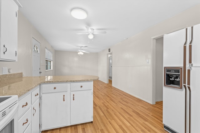 4416 33rd St, Lubbock, TX 79410 - kitchen with white appliances, white cabinetry, a peninsula, and light wood-style flooring