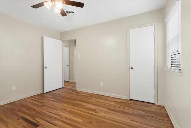 4416 33rd St, Lubbock, TX 79410 - unfurnished bedroom with light wood-style flooring, multiple windows, and ceiling fan