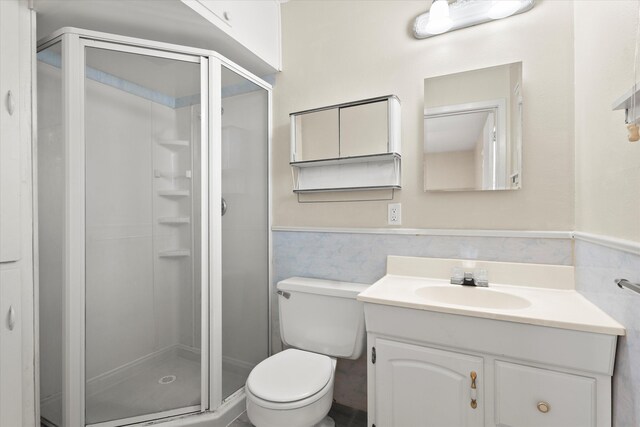 4416 33rd St, Lubbock, TX 79410 - bathroom with tile walls, vanity, a shower stall, and a wainscoted wall