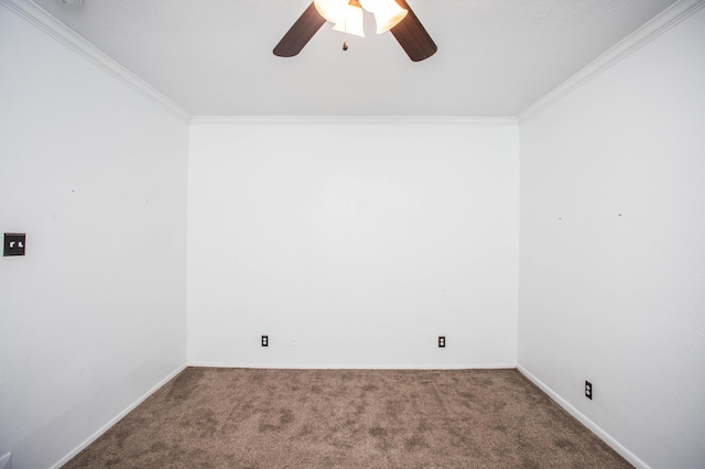 carpeted spare room featuring baseboards, ceiling fan, and crown molding