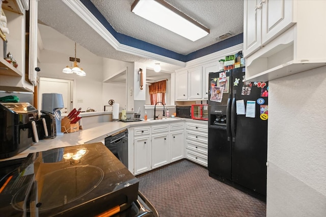 kitchen featuring white cabinetry, decorative light fixtures, sink, and black appliances