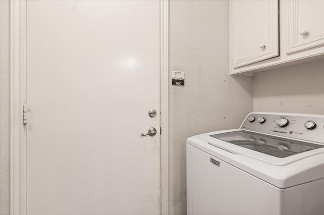 laundry room featuring washer / dryer and cabinets