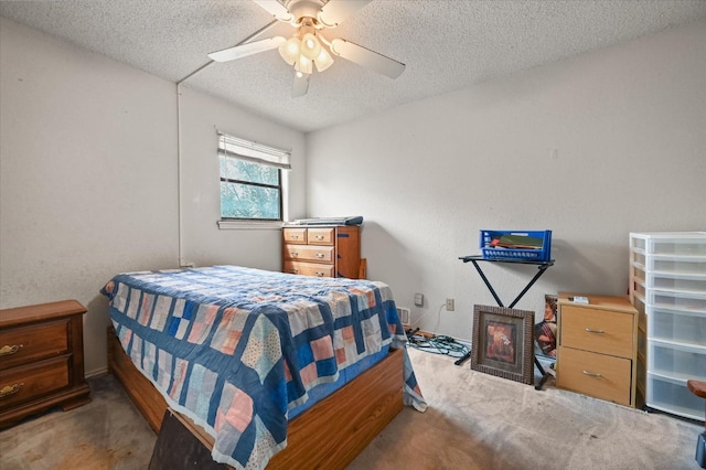 carpeted bedroom with ceiling fan and a textured ceiling