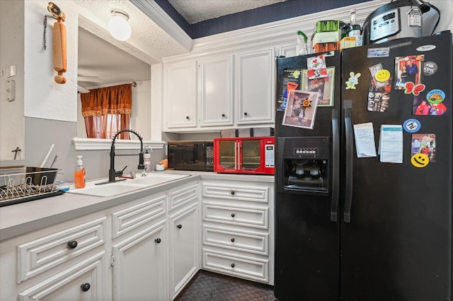 kitchen with white cabinetry, sink, a textured ceiling, and black appliances