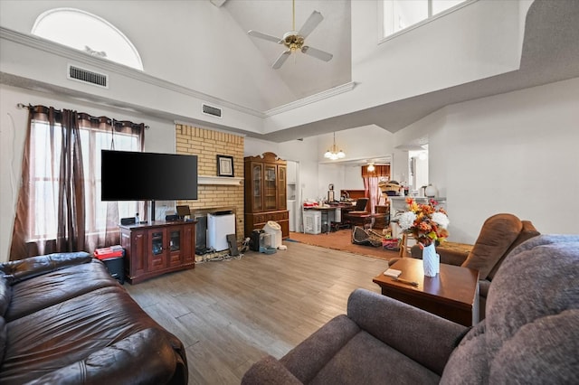 living room featuring ceiling fan, high vaulted ceiling, and light wood-type flooring