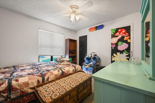 bedroom with ceiling fan and a textured ceiling