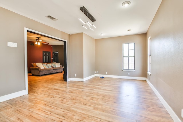 empty room featuring ceiling fan and light wood-type flooring