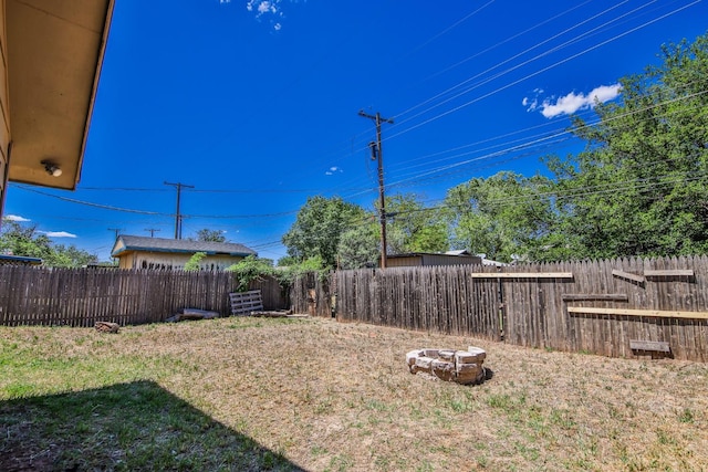 view of yard with an outdoor fire pit