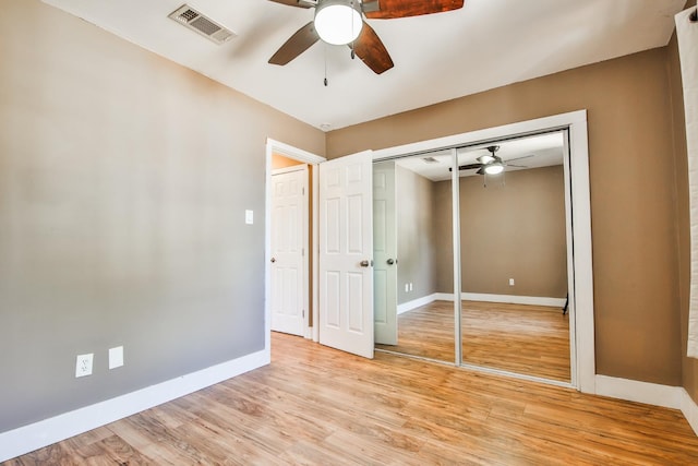 unfurnished bedroom with a closet, ceiling fan, and light hardwood / wood-style flooring