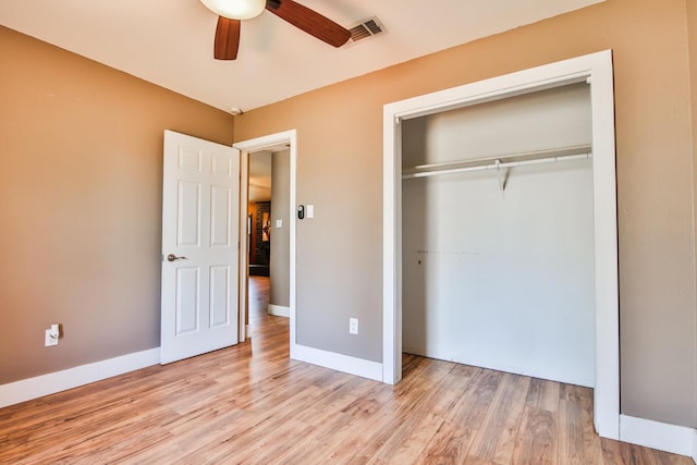 unfurnished bedroom with ceiling fan, light hardwood / wood-style floors, and a closet