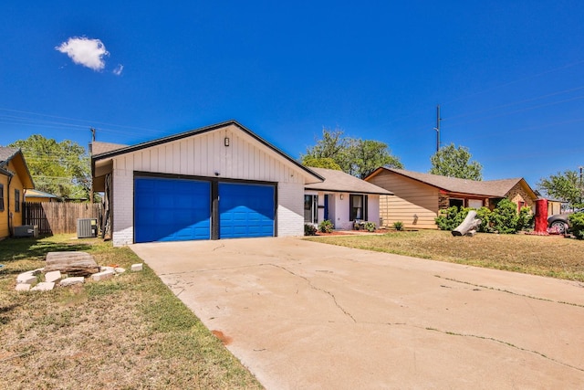 ranch-style home featuring central AC, a garage, and a front lawn