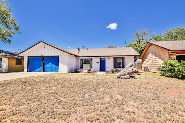 view of front of home featuring cooling unit and a garage