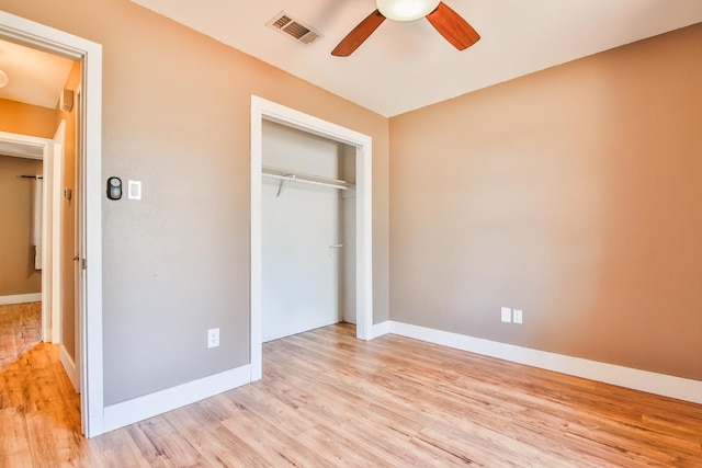 unfurnished bedroom featuring light hardwood / wood-style flooring, a closet, and ceiling fan