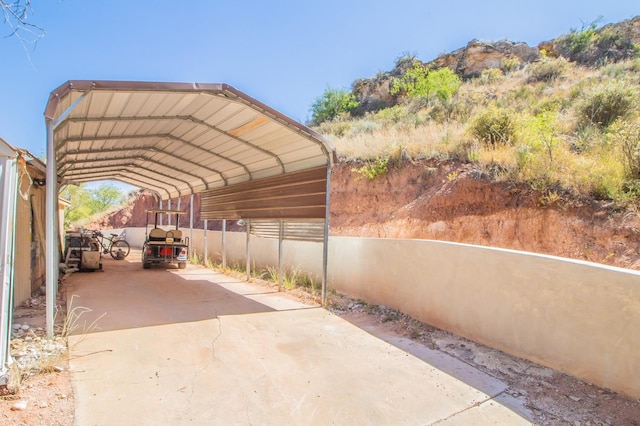 view of vehicle parking with a carport