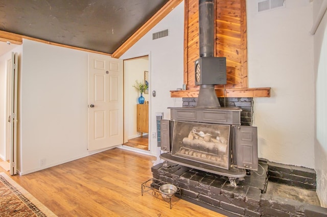 details with hardwood / wood-style floors and a wood stove