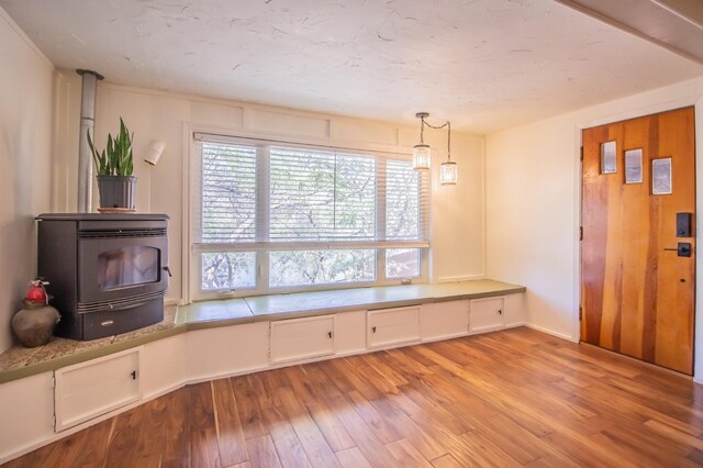 interior space with light hardwood / wood-style flooring and a wood stove