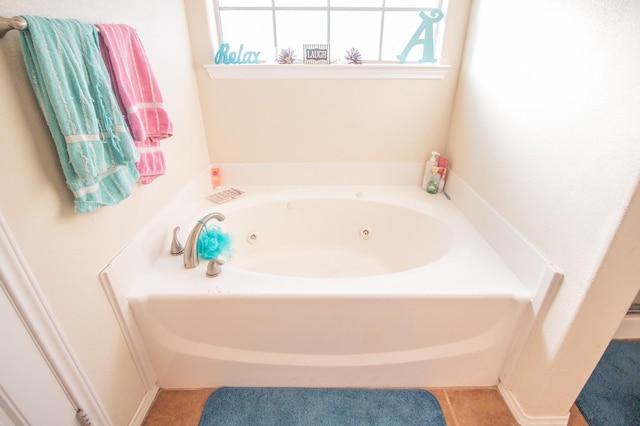 bathroom with tile patterned flooring and a bathtub