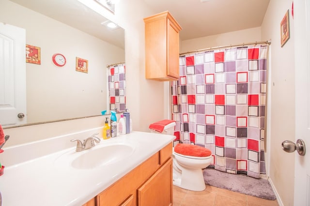 bathroom featuring vanity, toilet, and tile patterned flooring