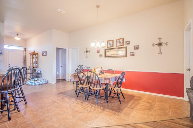 dining room with tile patterned floors and a chandelier