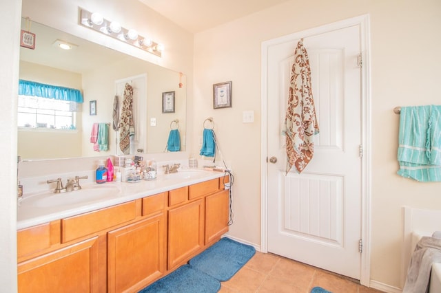 bathroom with vanity, a tub, and tile patterned floors