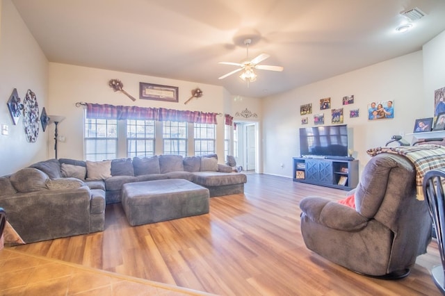 living room featuring ceiling fan and hardwood / wood-style floors