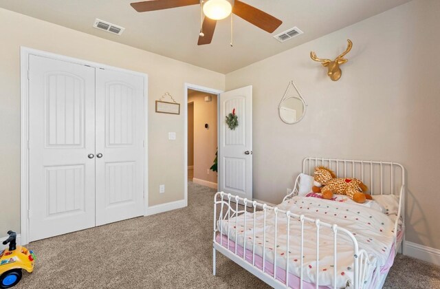 bedroom featuring ceiling fan, carpet flooring, and a closet