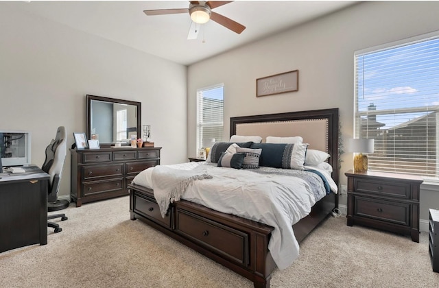 bedroom featuring light colored carpet and ceiling fan