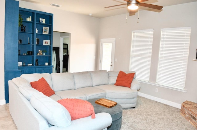 living room featuring light colored carpet and ceiling fan