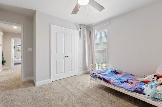 carpeted bedroom featuring a closet and ceiling fan