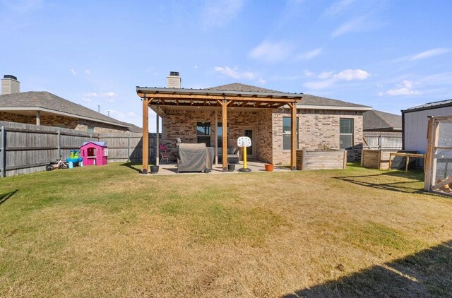 back of house with a yard and a patio area