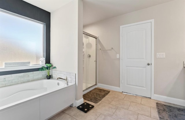 bathroom featuring tile patterned floors, shower with separate bathtub, and a healthy amount of sunlight