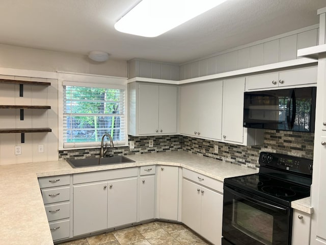 kitchen featuring tasteful backsplash, sink, and black appliances