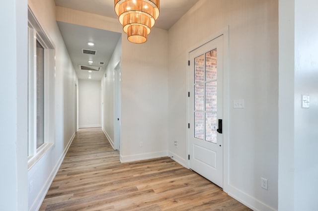 entrance foyer with a notable chandelier and light wood-type flooring