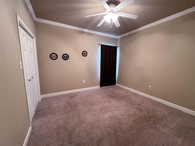 carpeted spare room featuring ornamental molding and ceiling fan