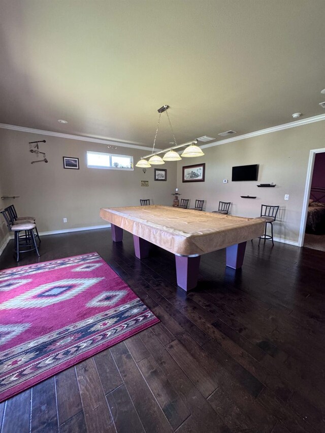 rec room with billiards, ornamental molding, and dark hardwood / wood-style floors