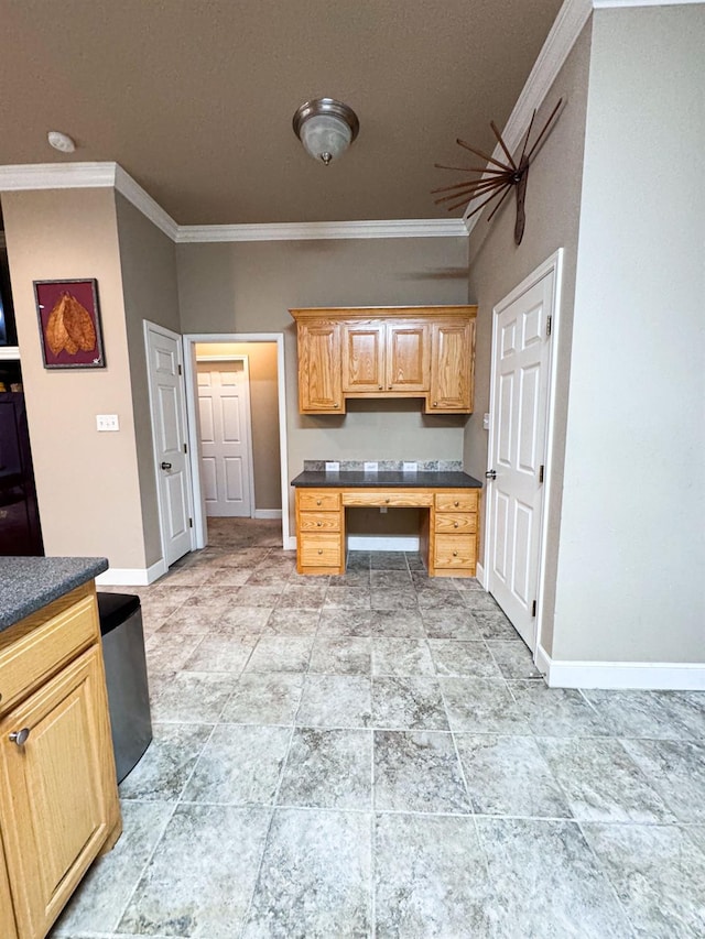 kitchen featuring ornamental molding and built in desk