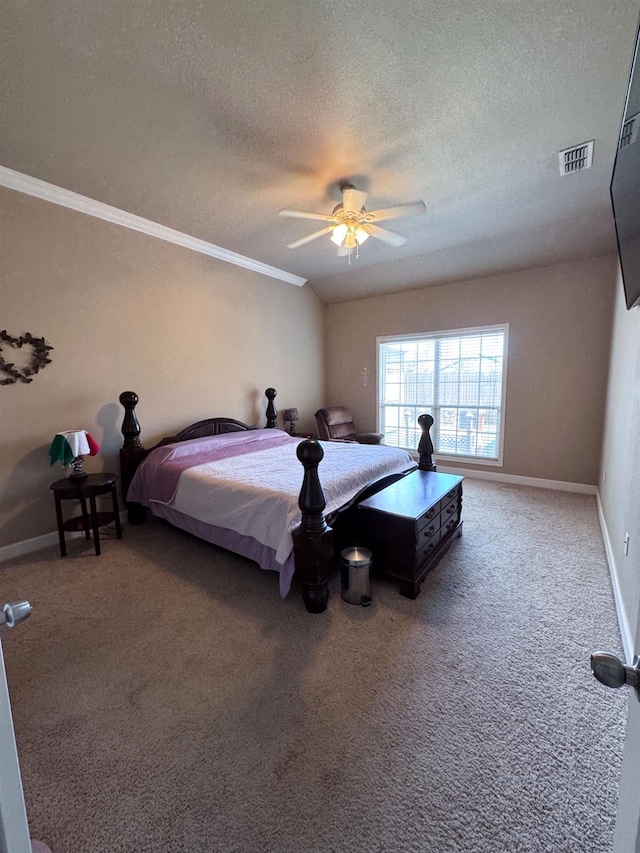 carpeted bedroom featuring ceiling fan, crown molding, and a textured ceiling