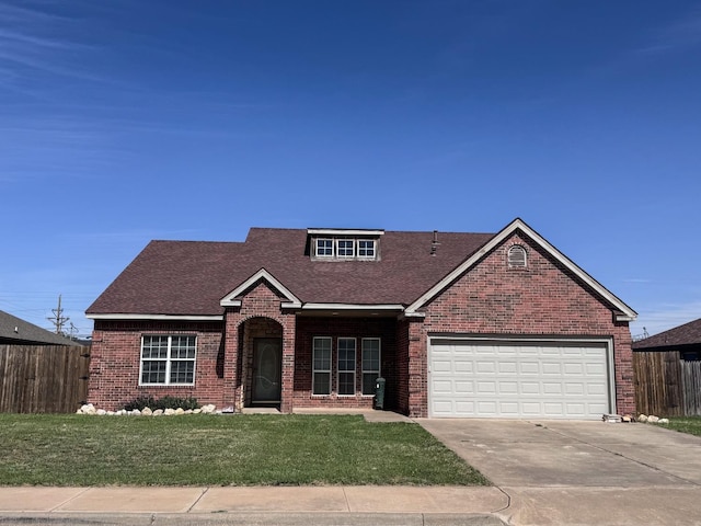 view of front property featuring a garage and a front lawn