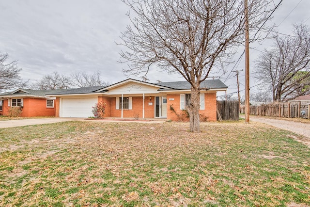 ranch-style home with a garage and a front lawn